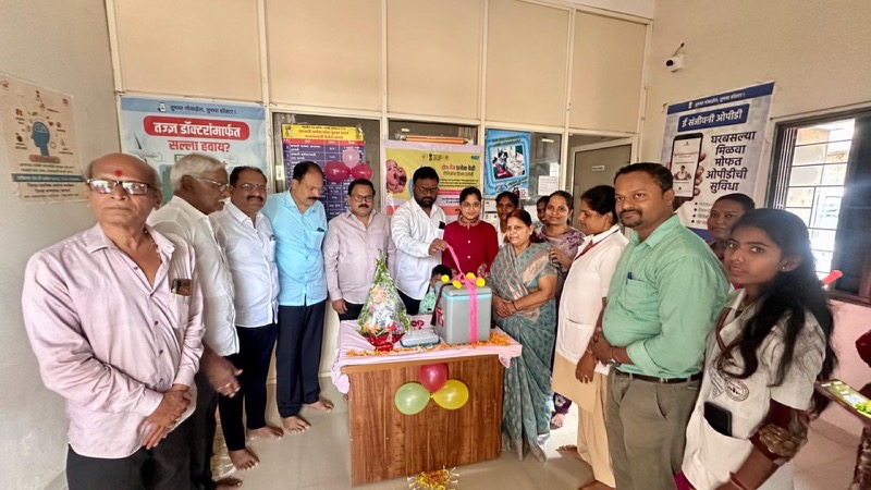 Residents and community representatives gathered around a celebration table